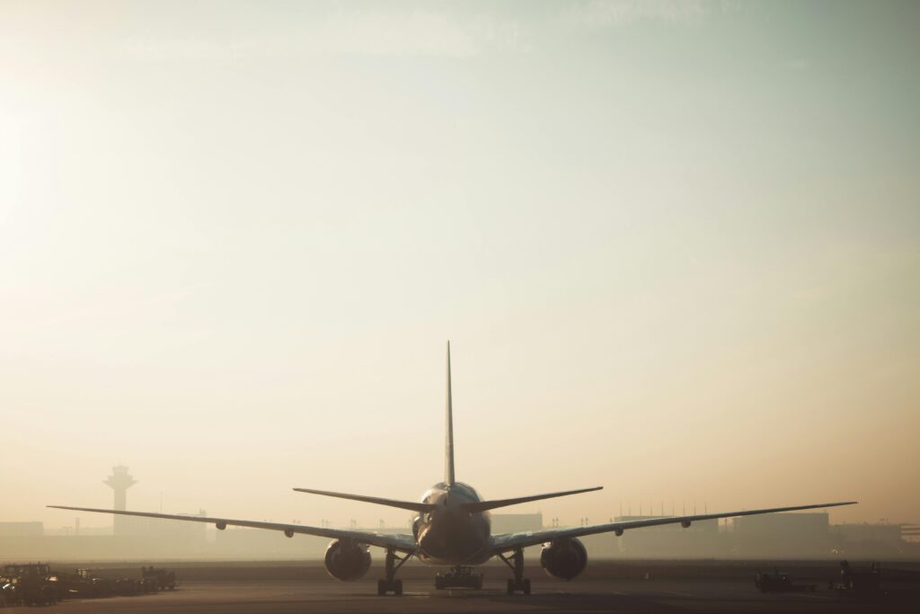 pexels-photo-249581-249581 A misty morning scene of a plane on the runway with a hazy sky background, showcasing air travel ambiance.